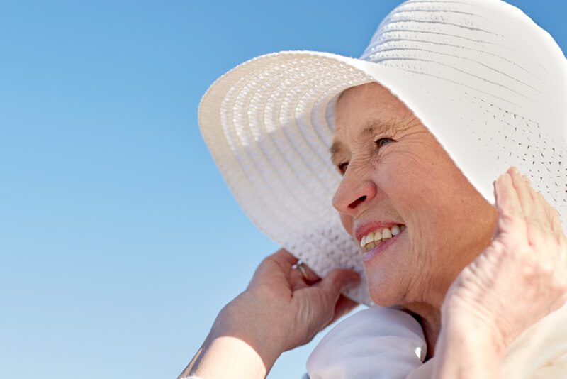 female elder wearing hat outdoors