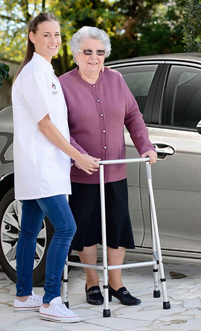1Heart caregiver helping elderly woman
