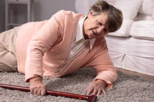 Elderly female on the floor with cane