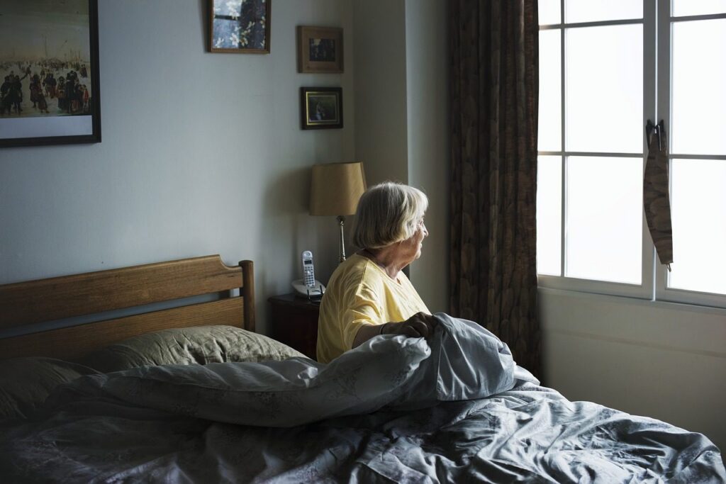 senior woman sitting up in bed