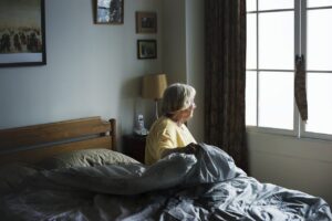 senior woman sitting up in bed
