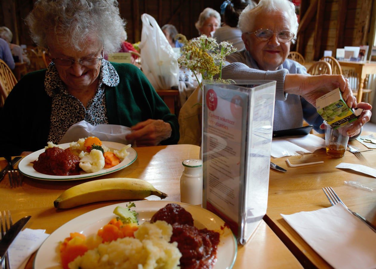 elderly women smiling and eating