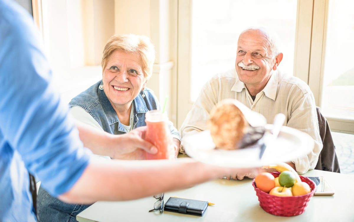 older couple smiling and eating