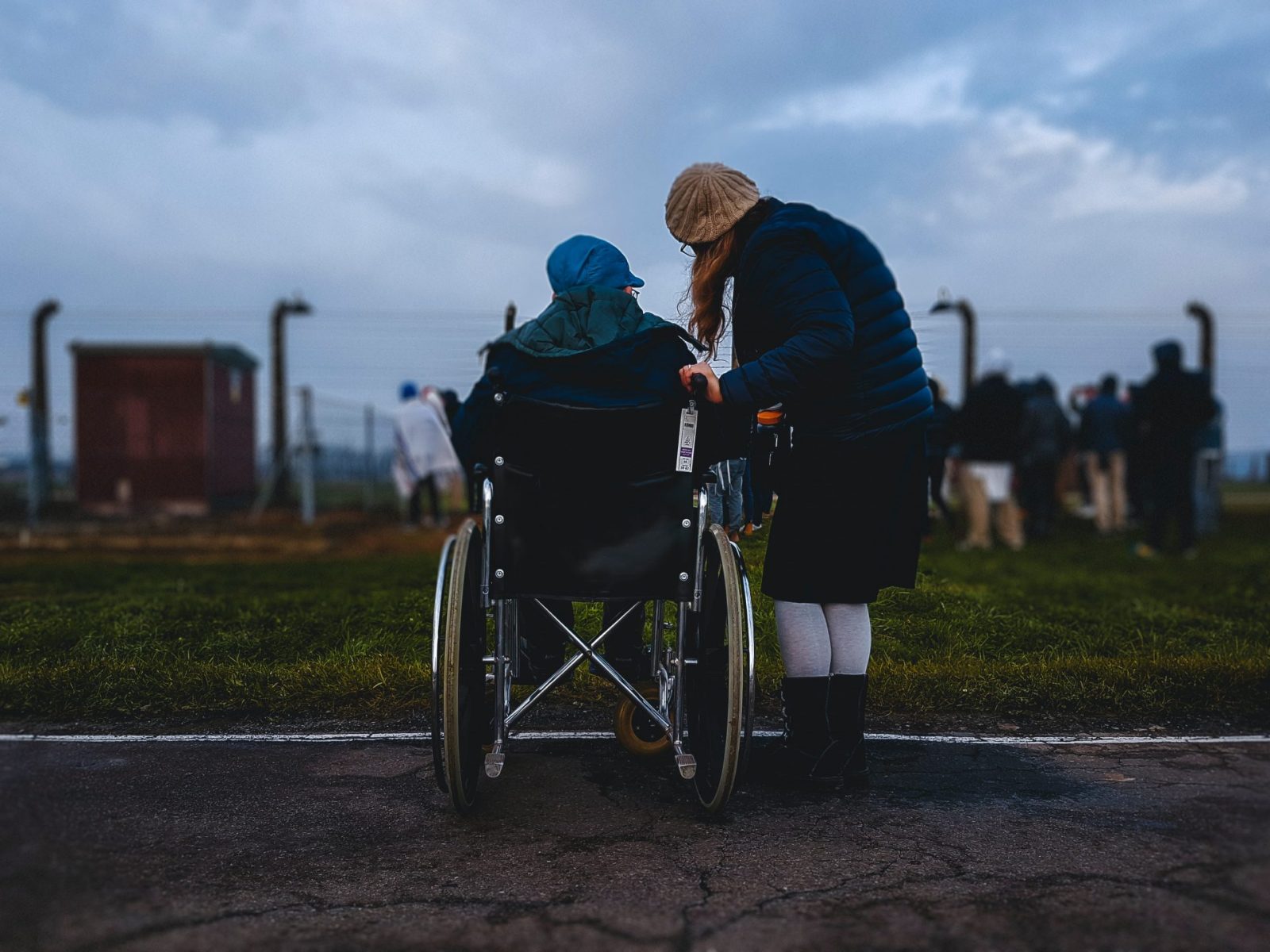 woman standing next to someone in a wheelchair