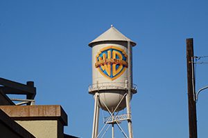 A white water tower with the Warner Brothers Studios logo.