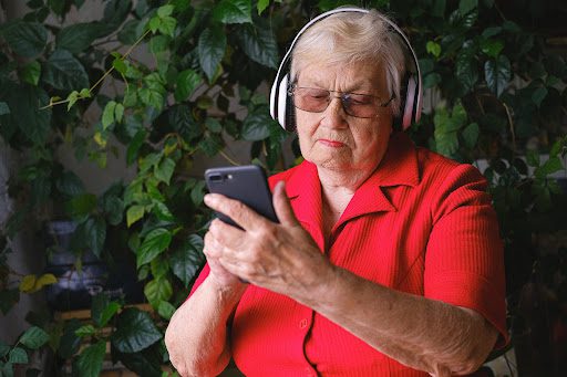 elder lady listening to something on smartphone
