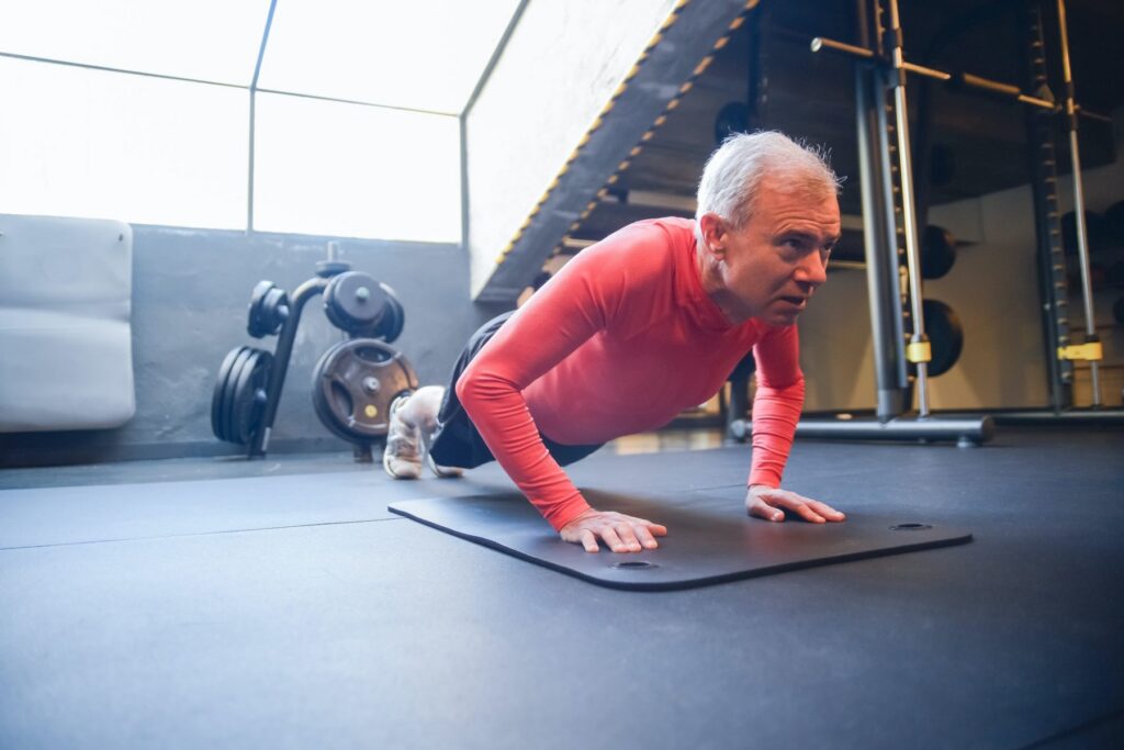 Senior exercising in gym