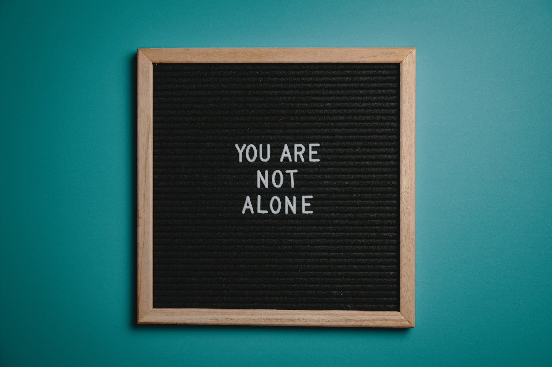 A board with the words “You are not alone.”
