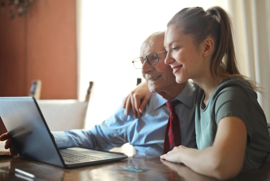 Elderly man and caregiver having a fun moment together